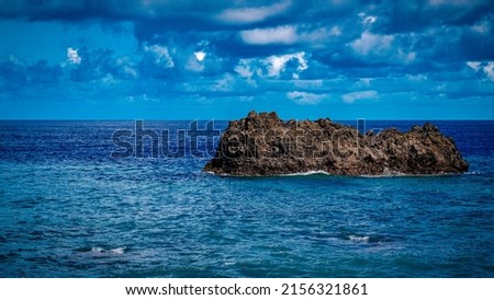 a big rock in the middle of the sea Latulalat City Door