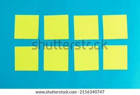 yellow blank note paper on blue paper background