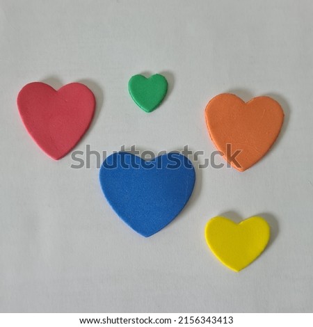 HEART OF VARIOUS COLORS ON A WHITE BACKGROUND