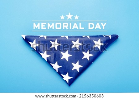 Folded USA flag on a blue background. Concept Memorial Day, Independence Day, July 4th. Flat lay, top view.