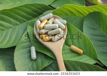 Herbal medicine in capsules from herb leaf on rustic wooden table with copy space for medical background. healthy eating with natural product for good living. Royalty-Free Stock Photo #2156351653