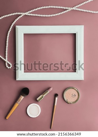 Horizontal art frame, make-up products and pearl jewellery on blush pink background as flatlay design, artwork print or photo album concept