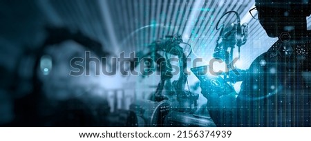 Factory Female Industrial Engineer working digital tablet control automation robot arms machine in intelligent factory industrial on real time monitoring system software.Digital future manufacture. Royalty-Free Stock Photo #2156374939