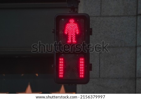 Close up of red Japanese pedestrian traffic light to warn pedestrian that it's not safe to cross the street. Royalty-Free Stock Photo #2156379997