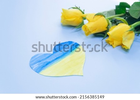 Fresh yellow rose. Purple tulips bouquet, next to it lies a heart in the form of the flag of Ukraine. Country symbol. Independence day of ukraine, flag day, constitution