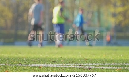 Anonymous Male Football Players Running on Soccer Field during Training Sparing Match