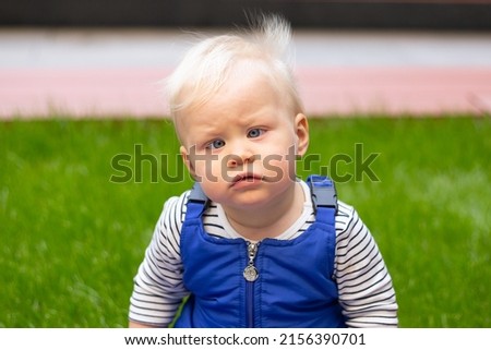 little baby boy portrait of child outdoor with strabismus eyes Royalty-Free Stock Photo #2156390701