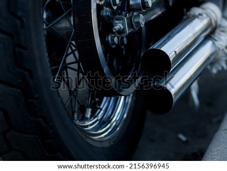 rear view of classical motorcycle pair of exhaust chrome pipes