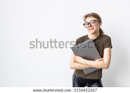 Portrait of a woman carrying laptop isolated over white background