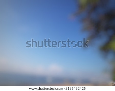 Defocused or blurred abstract background of a bright morning sky in the beach
