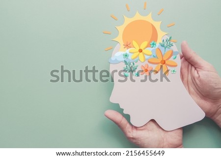 Hands holding paper brain with flowers and sunshine, positive mental health, mindfulness, wellness, self care concept Royalty-Free Stock Photo #2156455649