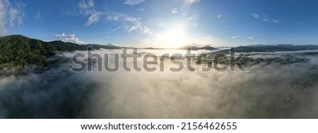 Aerial view Panorama of flowing fog waves on mountain tropical rainforest,Bird eye view image over the clouds Amazing nature background with clouds and mountain peaks in Thailand Royalty-Free Stock Photo #2156462655