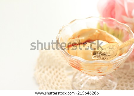 Caramel pudding with flower on background