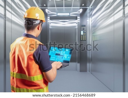 Technician check on elevator or passenger lift  Royalty-Free Stock Photo #2156468689