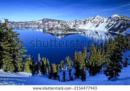 Blue mountain lake in winter. Winter mountain lake landscape. Lake in winter mountains. Winter snow scene on mountain lake Royalty-Free Stock Photo #2156477943