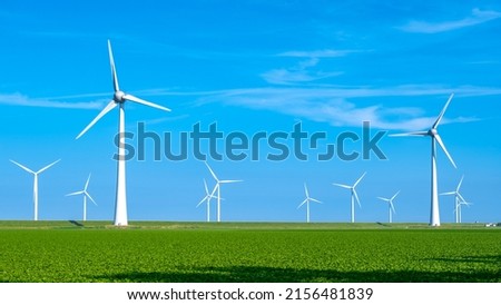 Offshore Windmill farm in the ocean Westermeerwind park, windmills isolated at sea on a beautiful bright day Netherlands Flevoland Noordoostpolder. Huge windmill turbines Royalty-Free Stock Photo #2156481839