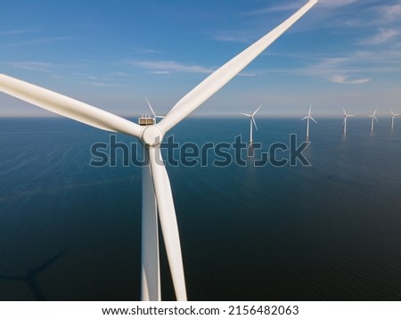 Offshore Windmill farm in the ocean Westermeerwind park, windmills isolated at sea on a beautiful bright day Netherlands Flevoland Noordoostpolder. Huge windmill turbines Royalty-Free Stock Photo #2156482063