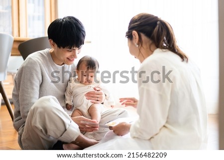 Family reading a storybook to their baby