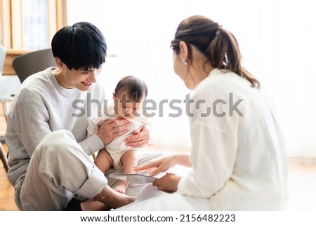 Family reading a storybook to their baby