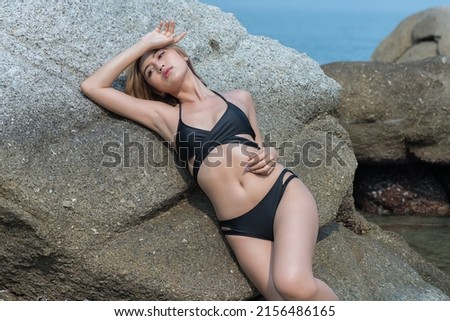 Portrait woman in bikini on vacation at the beach.