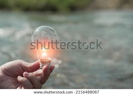 Light bulb Energy saving light bulb floating on water
