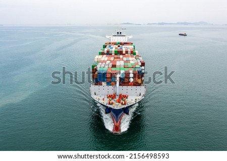 Big size container ship full speed sailing in deep sea for transporting cargo logistic import and export goods internationally around the world including Asia Pacific and Europe, front view from drone