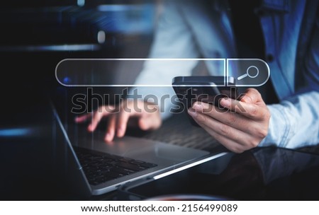 Data Search Technology Search Engine Optimization SEO concept. Business woman hand using laptop computer and mobile phone searching the information with search bar