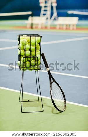 Vertical background image of tennis racket and ball basket at tennis court, copy space Royalty-Free Stock Photo #2156502805