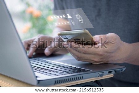 Two-step verification authorization for banking online, secure login access, SMS code security confirmation. man using laptop checking smartphone. Concept cyber security safe data protection business. Royalty-Free Stock Photo #2156512535