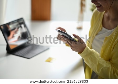 Happy young woman making shopping online, payment online on her smart phone