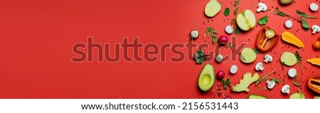 Top view of juicy fruits, vegetables and peppercorns on red background, banner