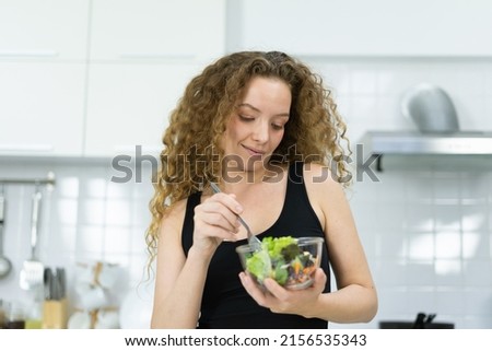 smart caucasian woman cooking vegetable salad in kitchen with copy space. beautiful caucasian woman cooking healthy diet fruit or vegetable in kitchen