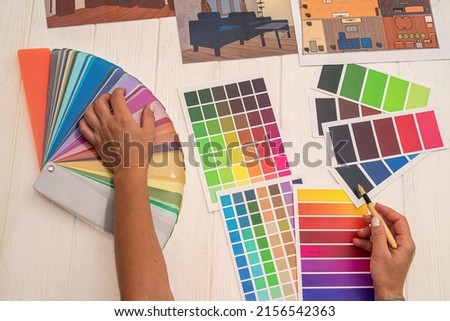 office workers consider a palette of colors that are selected for the design of a new kitchen. Color palette concept