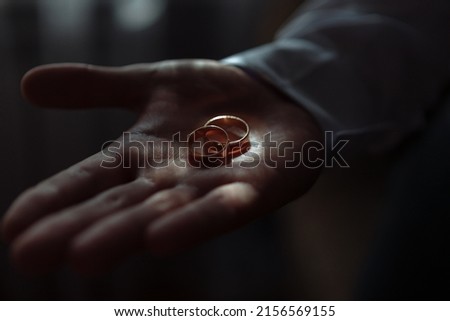 wedding rings in a hand.