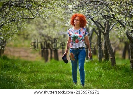 Redhead curly photographer woman shooting countryside lifestyle and landscape