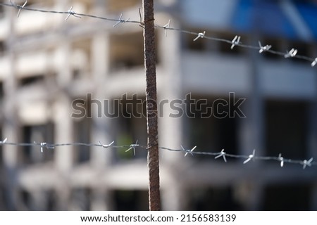 Close-up of security barbedwire fence, wire with clusters of short, sharp spikes. Fence or warfare obstruction, correctional institution concept Royalty-Free Stock Photo #2156583139