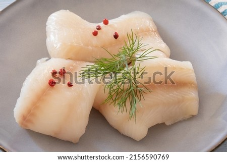 close up of raw halibut fillet on a plate
