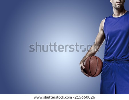 Basketball player on a  blue uniform, on a blue background.