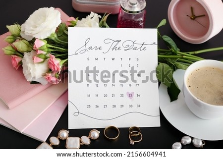 Wedding calendar with marked date, cup of coffee and bridal accessories on table, closeup
