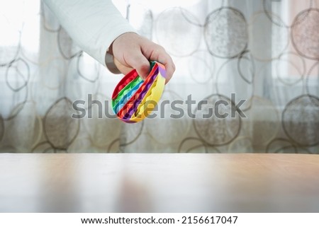 man holding stress reliever toy, , manual doll toy, isolated on curtain background