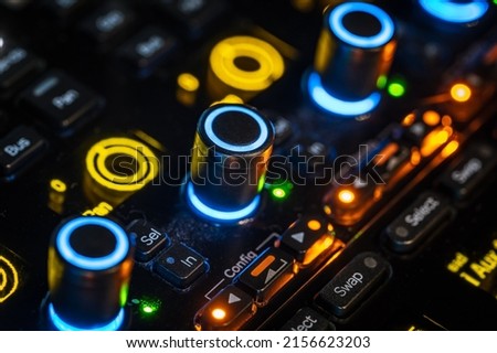 Closeup of sound mixing panel knobs and switches