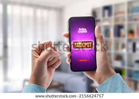 User winning jackpot on online casino app, online games and gambling concept, POV shot Royalty-Free Stock Photo #2156624757