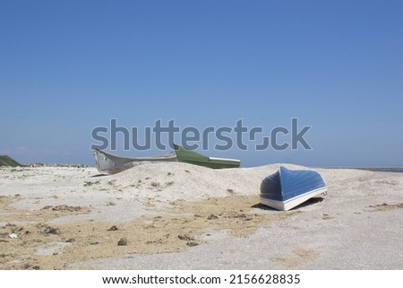 Boats on empty summer sandy beach of Black sea coast  
