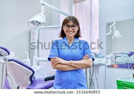 Portrait of smiling nurse looking at camera in dentistry. Royalty-Free Stock Photo #2156640893