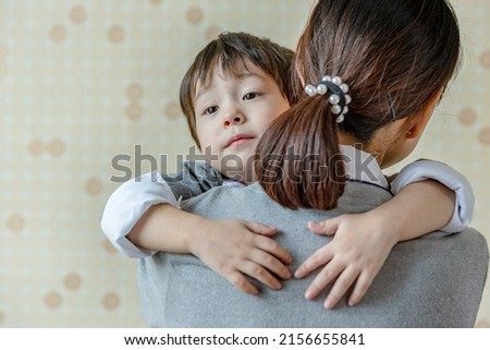 asian little boy hug mom.