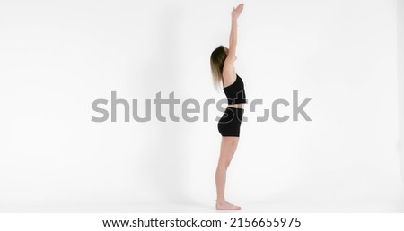 Blonde woman doing yoga exercise in studio close up