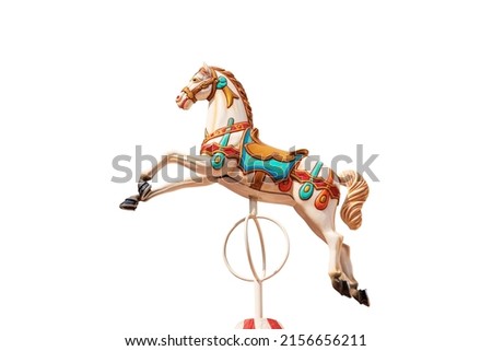 Close-up of a plastic horse of a carousel horses or merry-go-round isolated on white background. Italy, Europe. Royalty-Free Stock Photo #2156656211