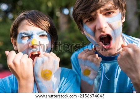Brothers encouraging the Argentina team. Royalty-Free Stock Photo #2156674043