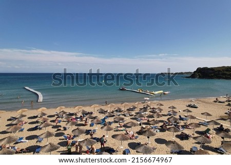 St. Nicholas, Zakynthos, Greece - September 2021: Beach is a beautiful and very clean sandy beach with calm waters. The beach is the most popular and organized beach on the island and water sports