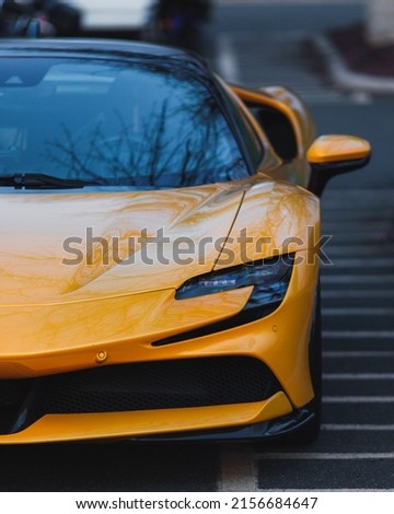 A front view of a luxurious yellow supercar parked outside Royalty-Free Stock Photo #2156684647